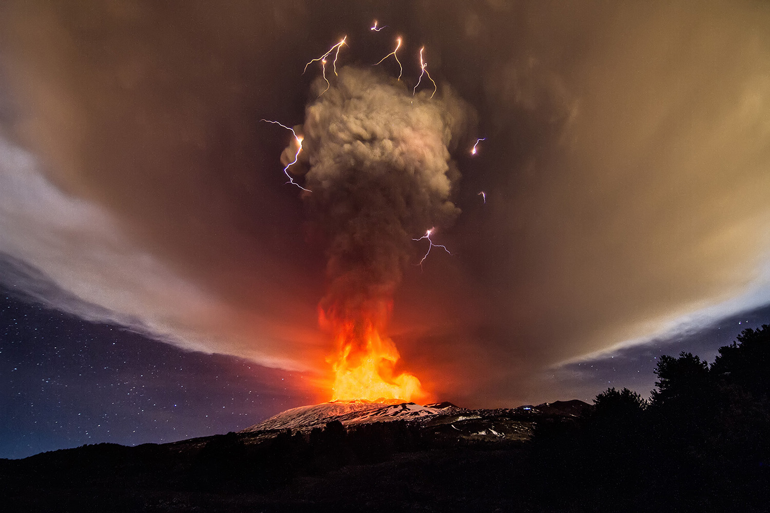 Explosions from Mount Etna's Voragine crater light up night sky